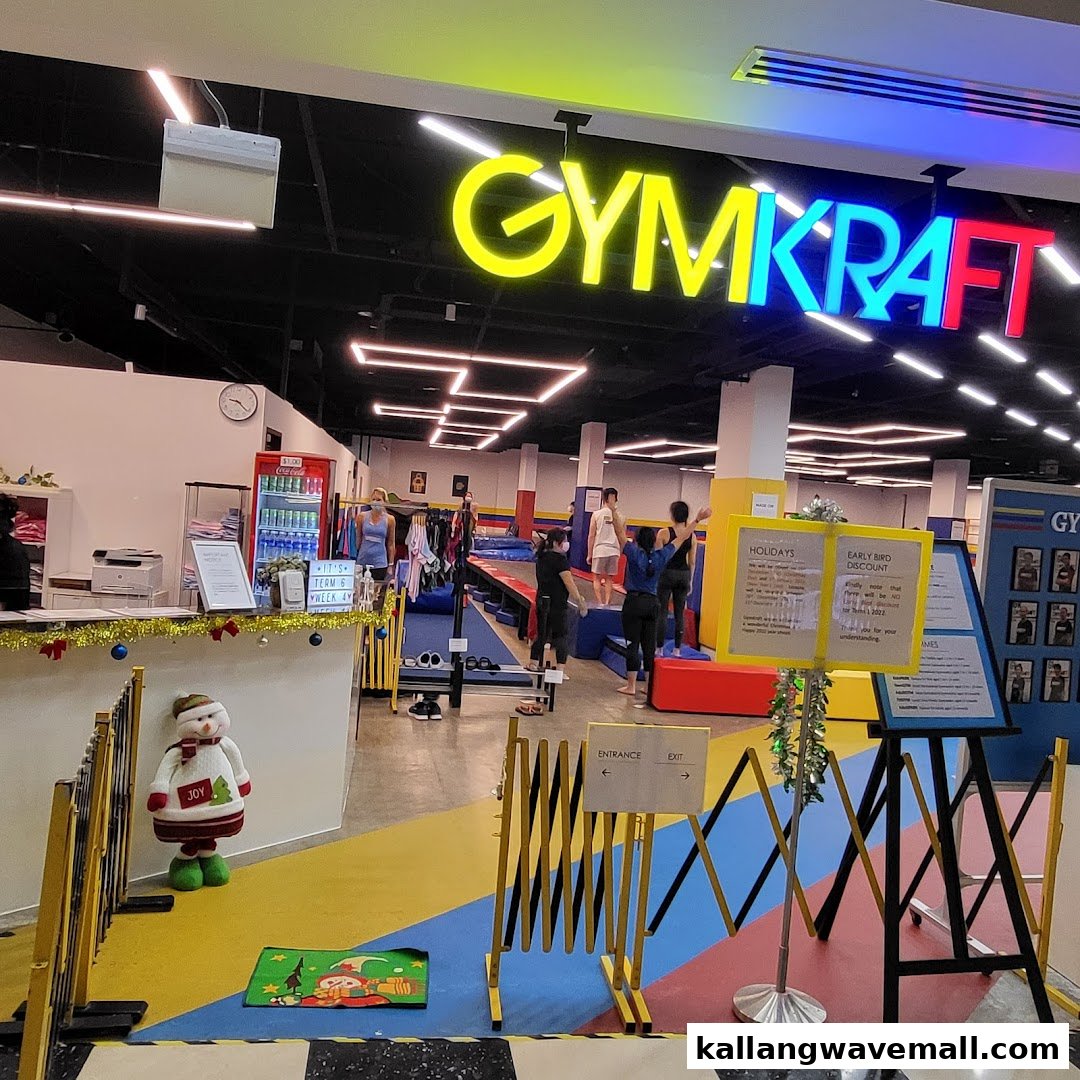 Colorful entrance of GymKraft, a gymnastics and fitness center, with reception and activity view.