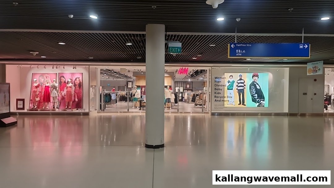 The H&M store entrance features window displays with mannequins and prominent branding in a mall setting.