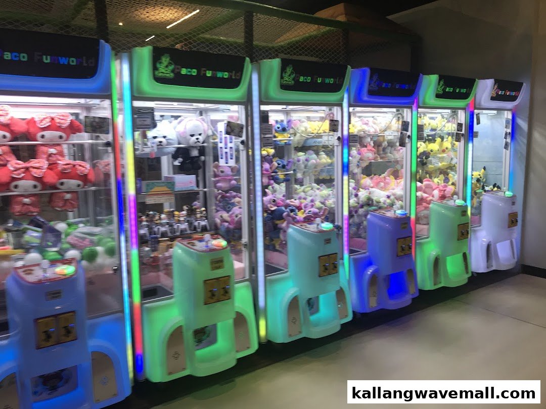 A row of colorful claw machines filled with various plush toys, offering entertainment.
