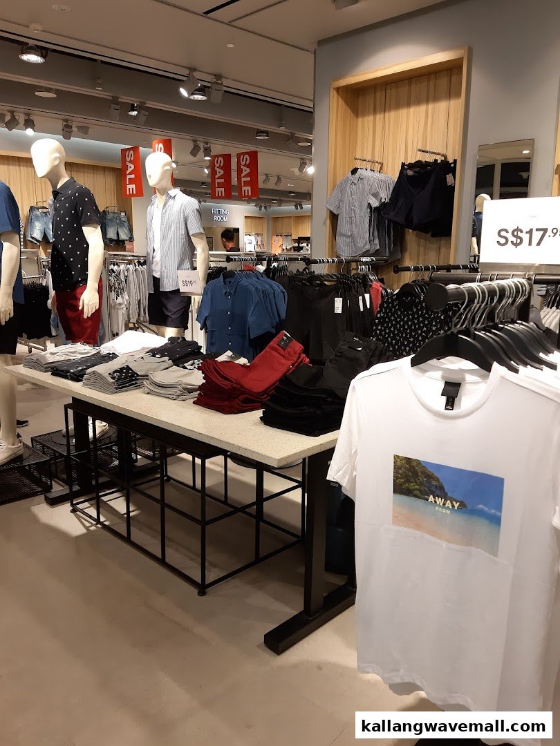 Interior view of an H&M store featuring mannequins, clothing displays, and sale signs.