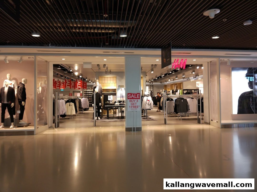 The H&M shop front features mannequins, clothing displays, and prominent 'SALE' and 'BUY 3 GET 1 FREE' signs.