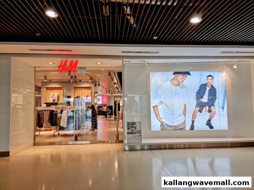 The H&M store entrance features a bright logo, visible clothing racks, and a large fashion display.