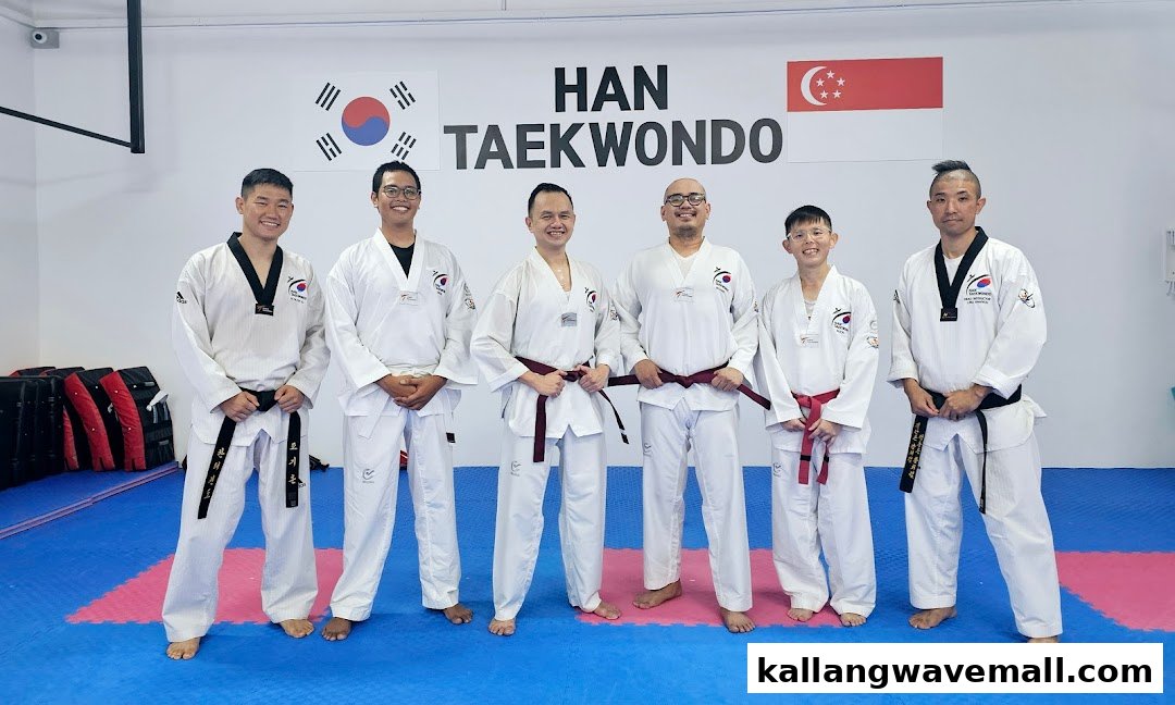 A group of Taekwondo practitioners in uniform posing inside the HAN Taekwondo studio.