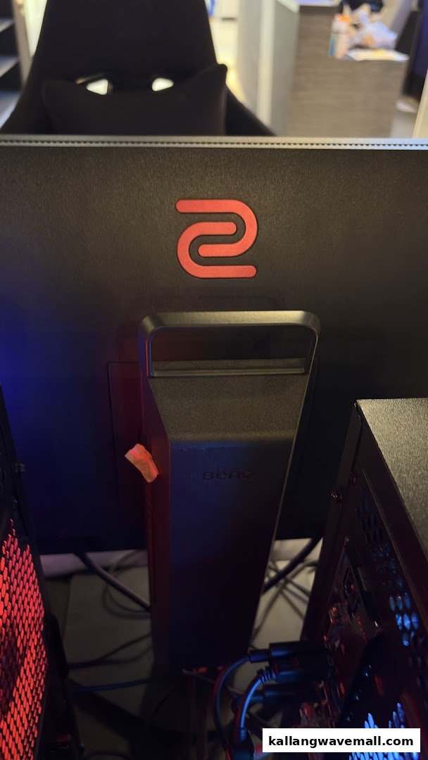 A close-up of a high-performance gaming monitor and PC setup, featuring Zowie/BenQ equipment.