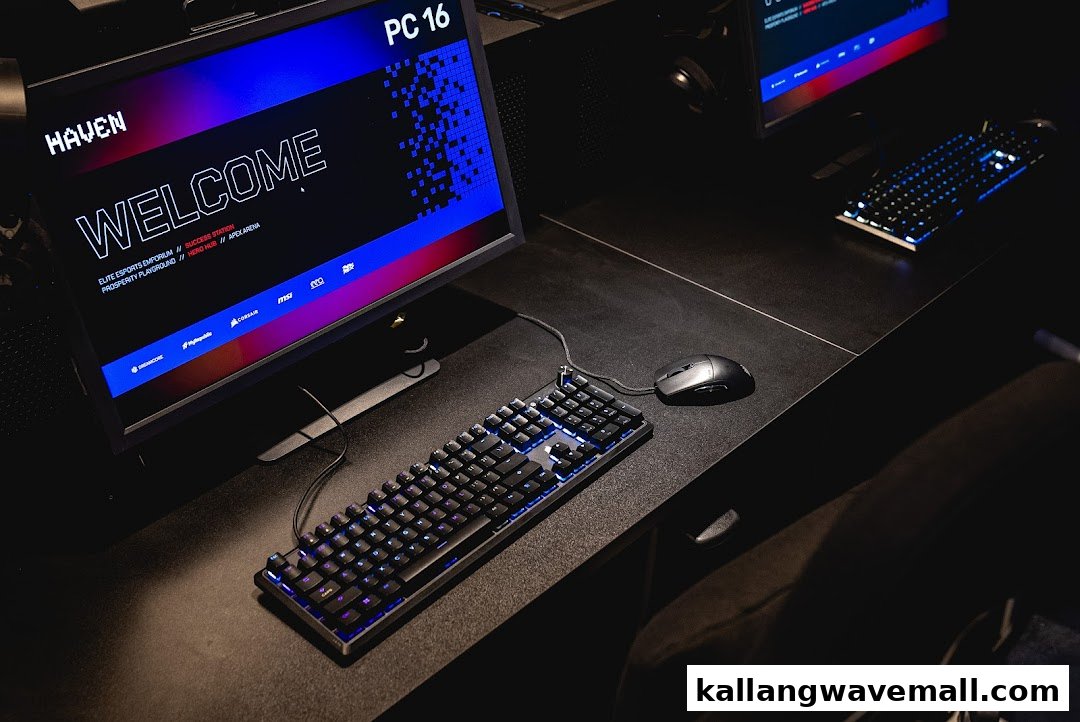 A high-performance gaming PC setup with a backlit keyboard and mouse at HAVEN Esports LAN Cafe.