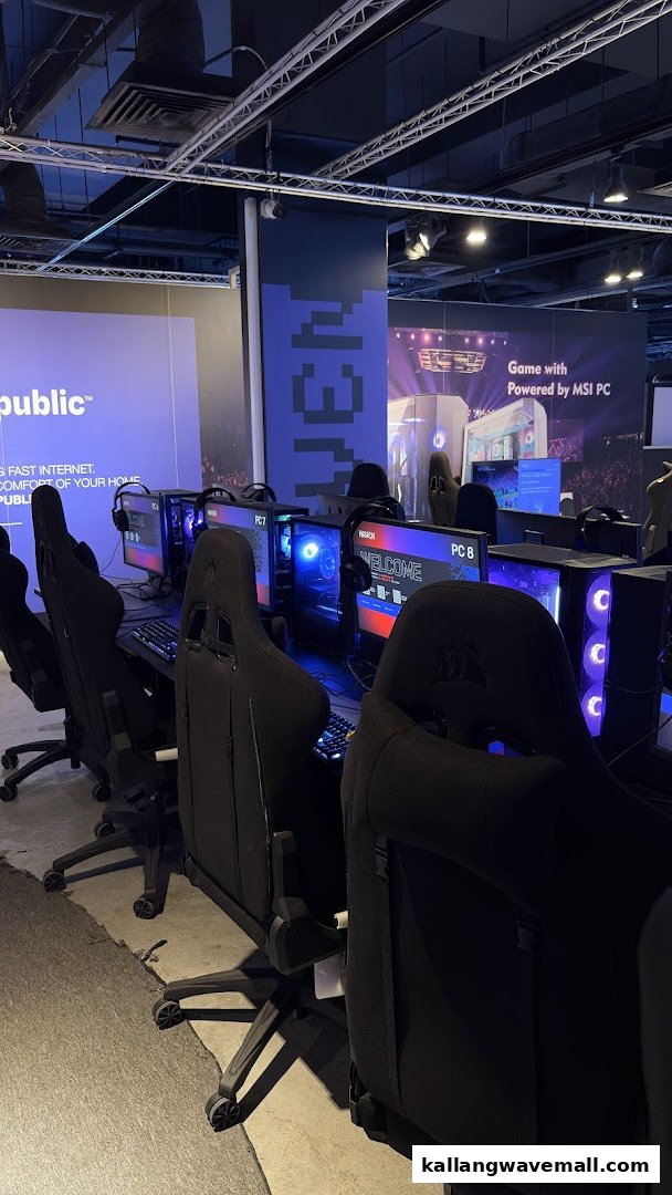 Row of gaming PCs with comfortable chairs in a modern esports LAN cafe, ready for play.
