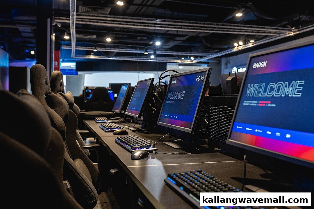 Rows of high-performance gaming PCs with ergonomic chairs in a modern LAN cafe.