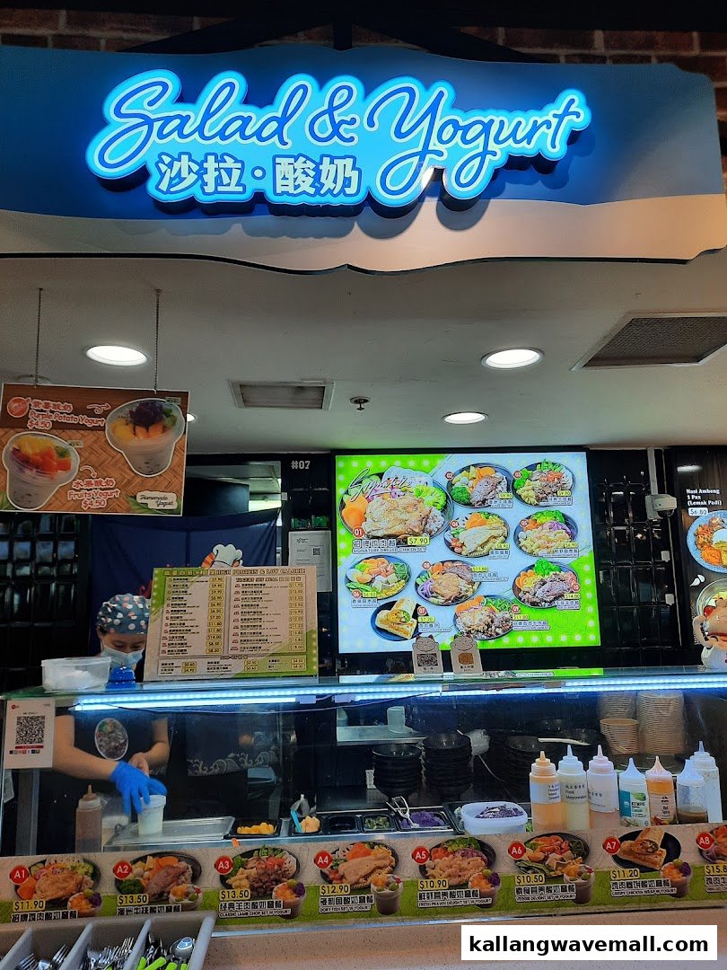 A vibrant 'Salad & Yogurt' stall featuring fresh ingredients, prepared dishes, and a friendly staff member.