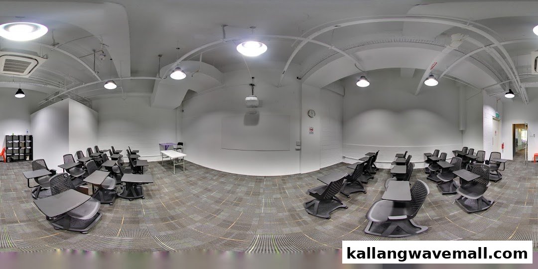 A spacious, modern classroom or training room with individual desks and chairs.