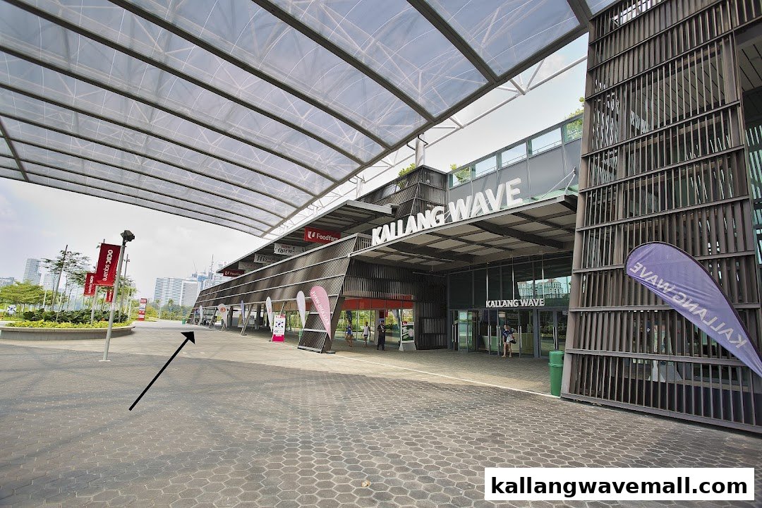 The modern, spacious entrance of Kallang Wave mall, featuring a distinctive roof structure.