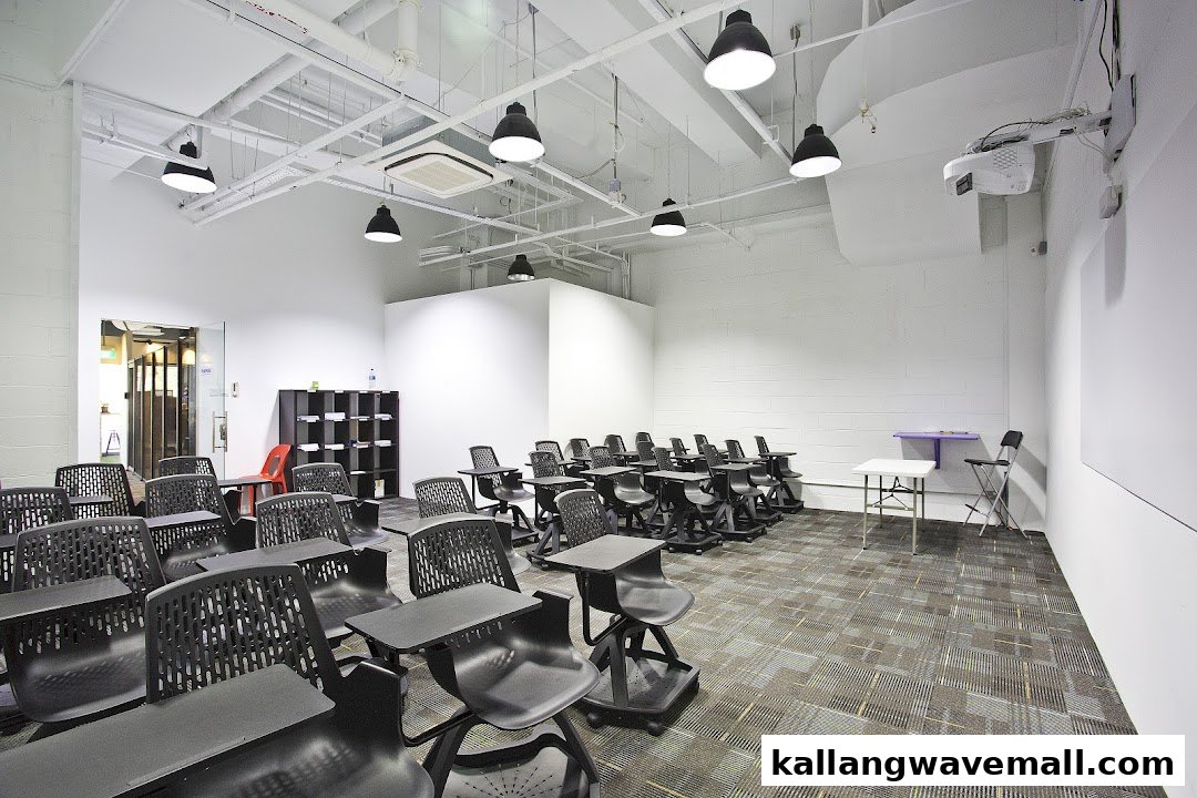 A modern, well-lit classroom with numerous student desks and chairs, ready for learning.