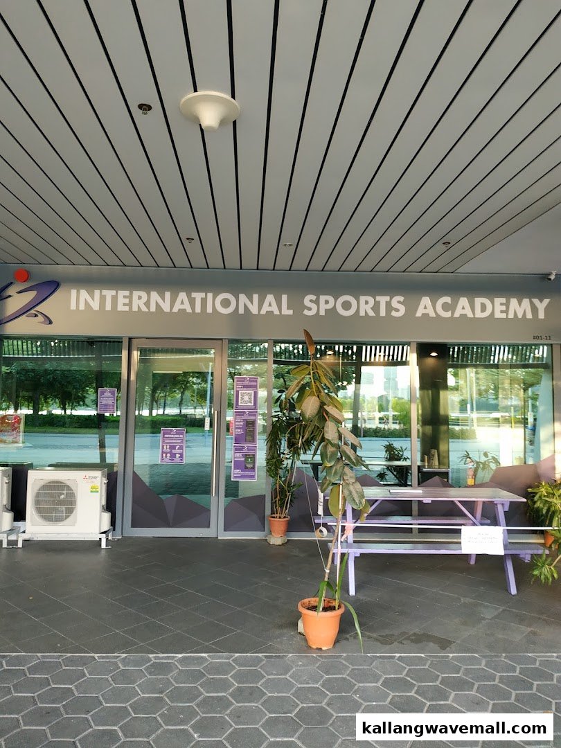 The entrance of International Sports Academy ISA with glass doors and outdoor seating.
