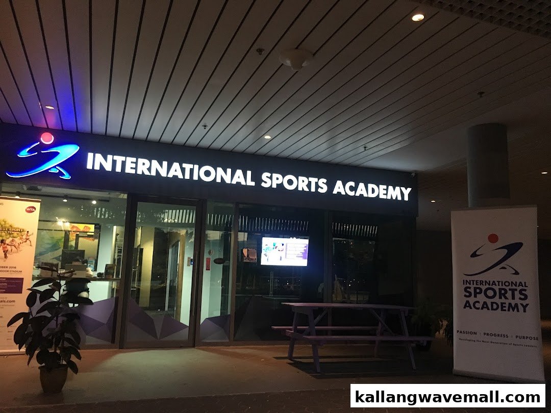 The illuminated storefront of International Sports Academy ISA at night, featuring its logo and entrance.