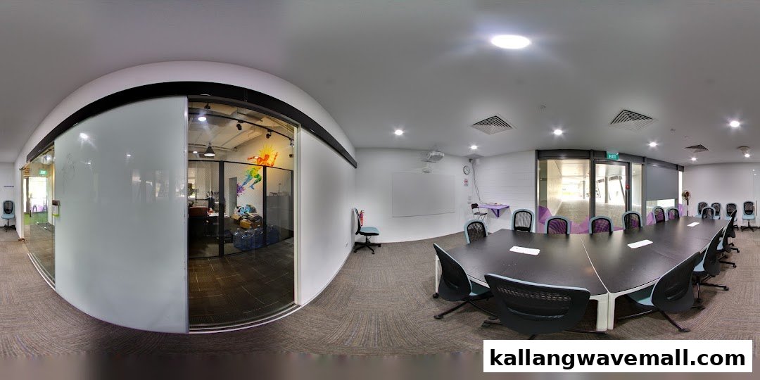 A modern meeting room with a large table and an adjacent office space at International Sports Academy.