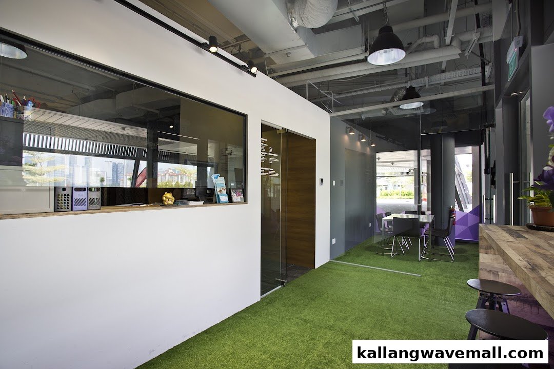 Modern interior of International Sports Academy ISA featuring a reception desk, artificial turf, and seating.