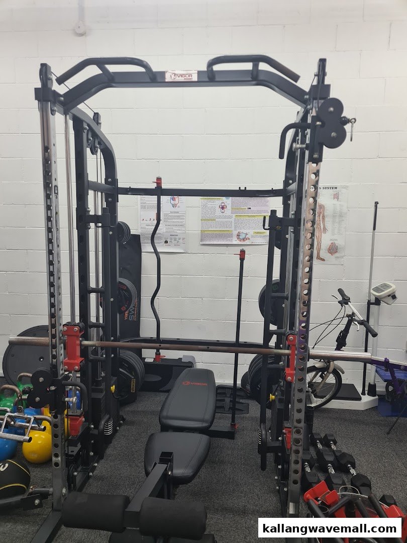 An interior view of a gym featuring a power rack, weight bench, and various fitness equipment.