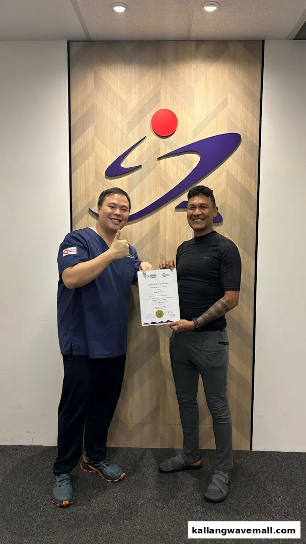 Two men, one in scrubs, holding a certificate in front of the International Sports Academy logo.