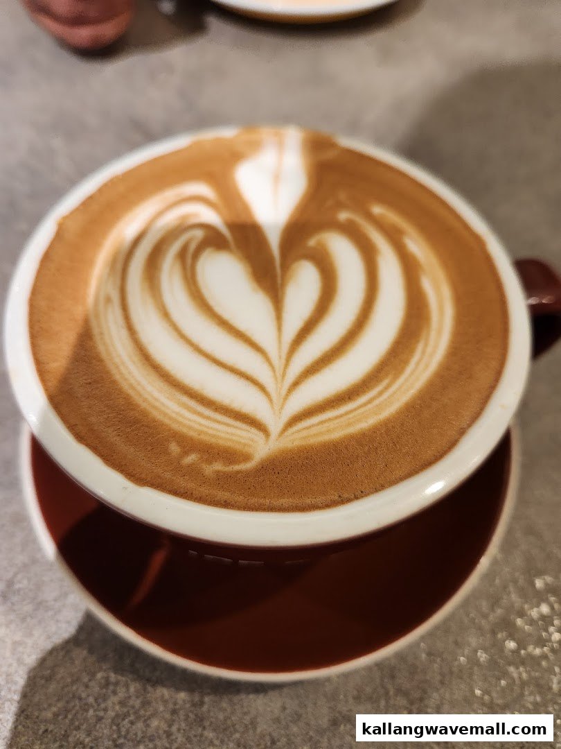 A close-up of a coffee cup featuring intricate heart-shaped latte art.