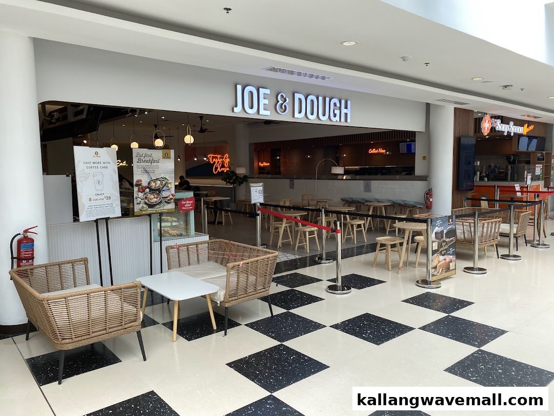 The inviting storefront of Joe & Dough, featuring outdoor seating and promotional displays in a mall setting.