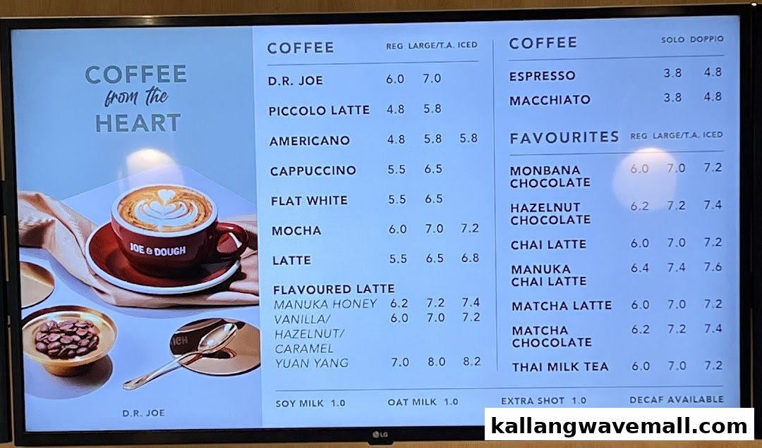 A digital menu board displaying coffee, flavoured lattes, and favourite beverages with prices at Joe & Dough.