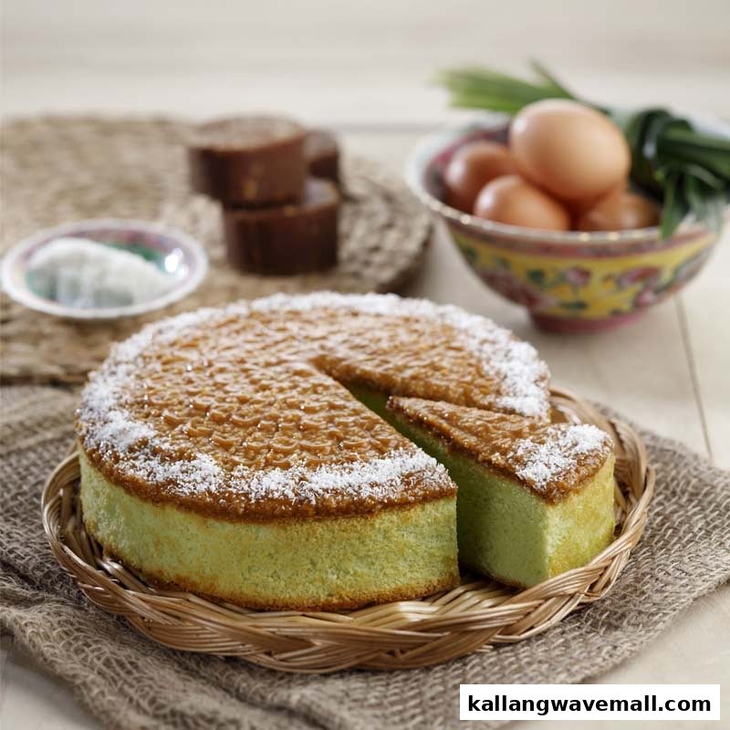 A pandan cake with a slice removed, garnished with coconut, alongside eggs and palm sugar.
