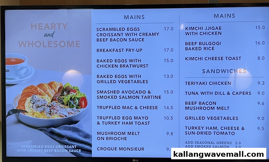 A digital menu board displaying a variety of hearty mains and sandwiches with prices.