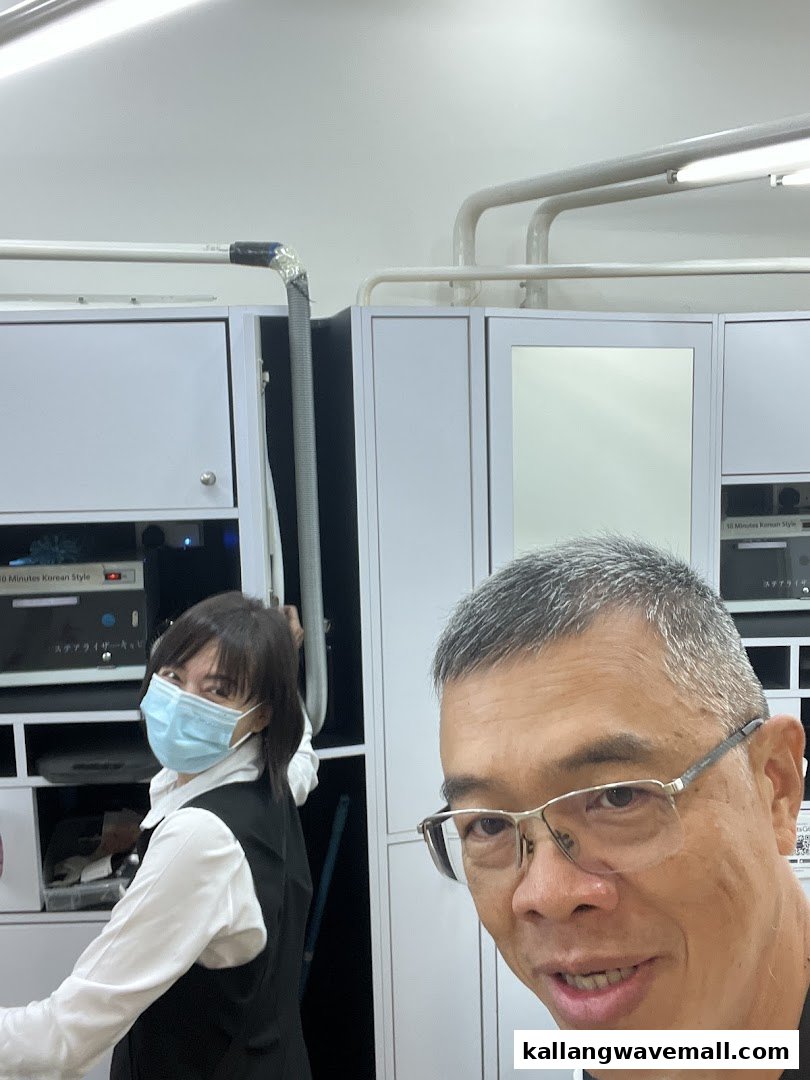 Two individuals, one masked, inside Kcuts, a modern salon offering 10-minute Korean style haircuts.