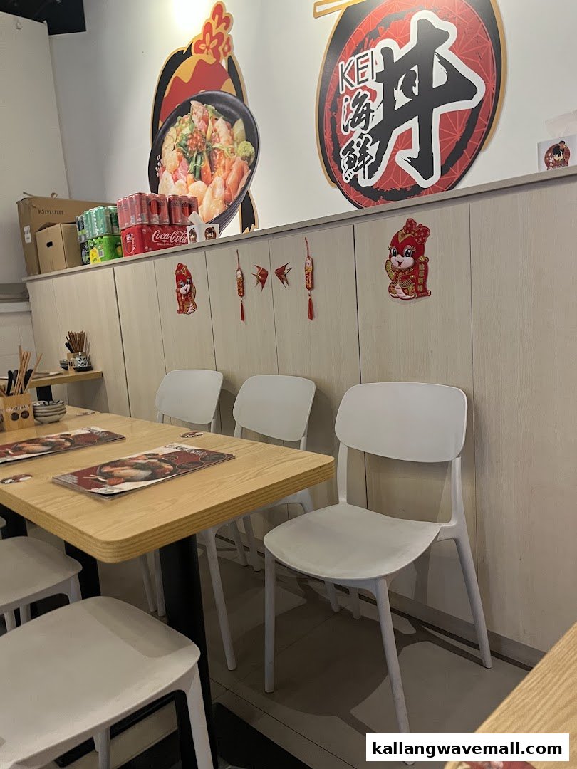 Interior view of Kei Kaisendon restaurant with tables, chairs, and wall decorations.