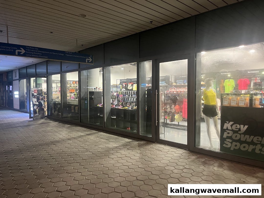 Exterior view of Key Power Sports, showcasing athletic apparel and footwear through large windows.