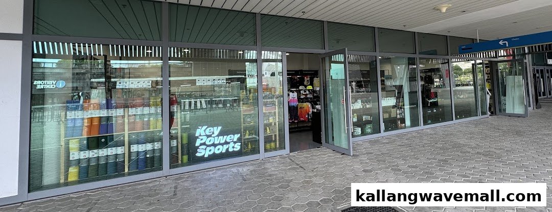 Exterior view of Key Power Sports shop with glass facade, open door, and visible merchandise.