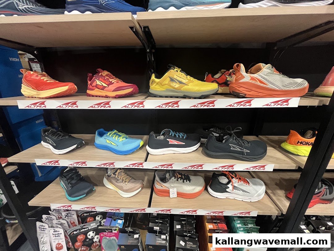 Shelves showcasing a vibrant collection of Altra and Hoka running shoes in a sports store.