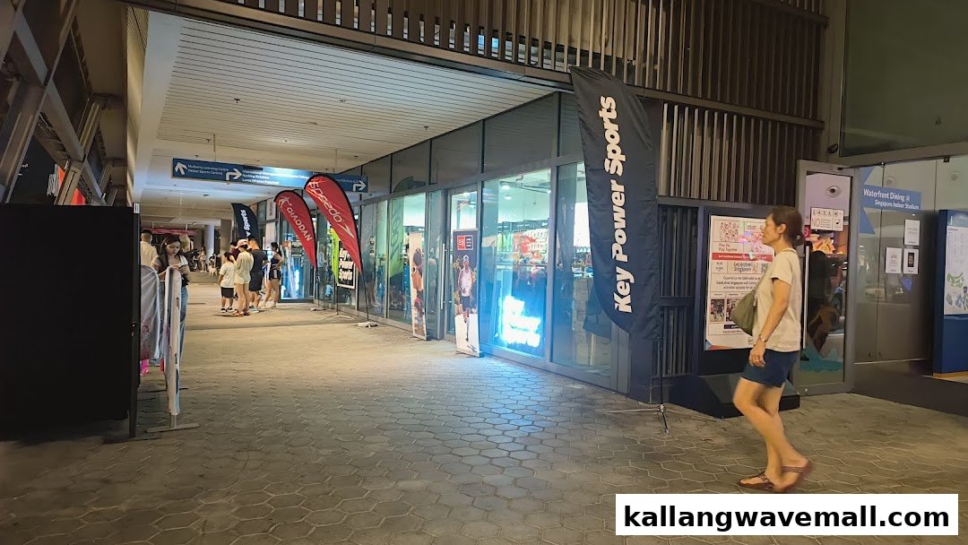 Exterior view of Key Power Sports shop with promotional banners and people walking by.