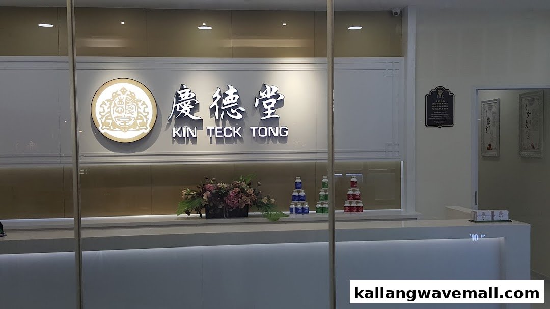 A clean and modern reception area of Kin Teck Tong TCM Clinic, featuring its illuminated logo and product displays.
