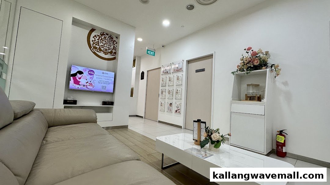 A clean and comfortable waiting area with a sofa, TV, and floral decor at Kin Teck Tong TCM Clinic.
