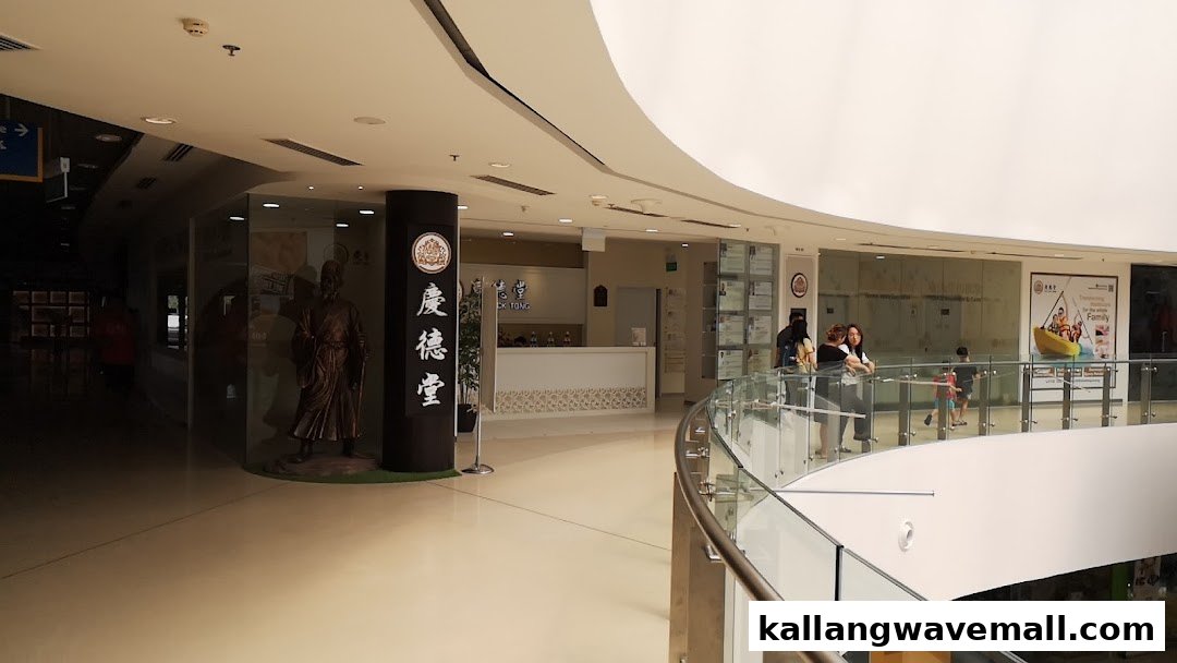 The image shows the welcoming reception area of Kin Teck Tong TCM Clinic with a traditional statue.