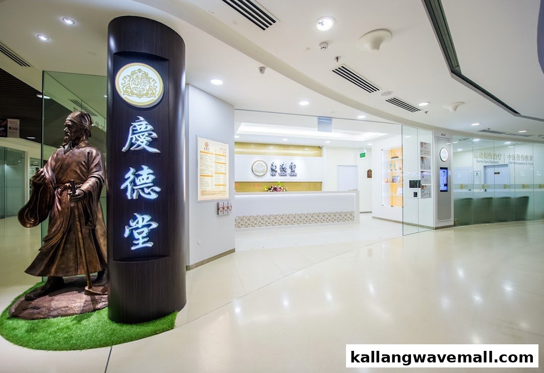 The image shows the bright, modern interior of Kin Teck Tong TCM Clinic, featuring a traditional statue and reception area.
