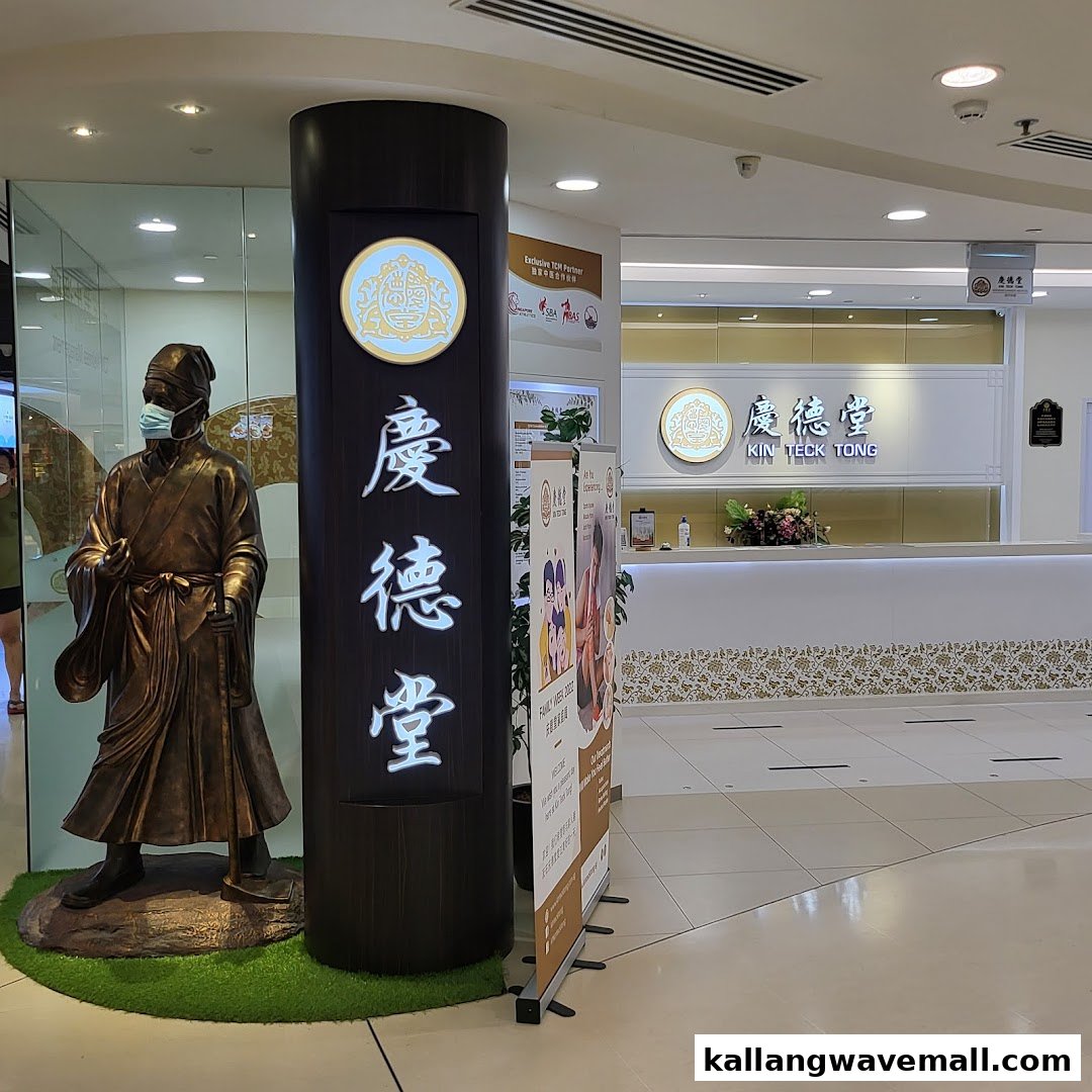The entrance of Kin Teck Tong TCM Clinic, featuring a traditional statue and reception area.