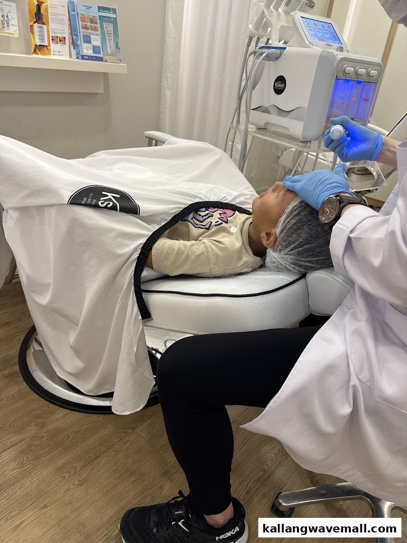A customer receives a facial treatment at Kskin, showcasing the professional service and equipment.