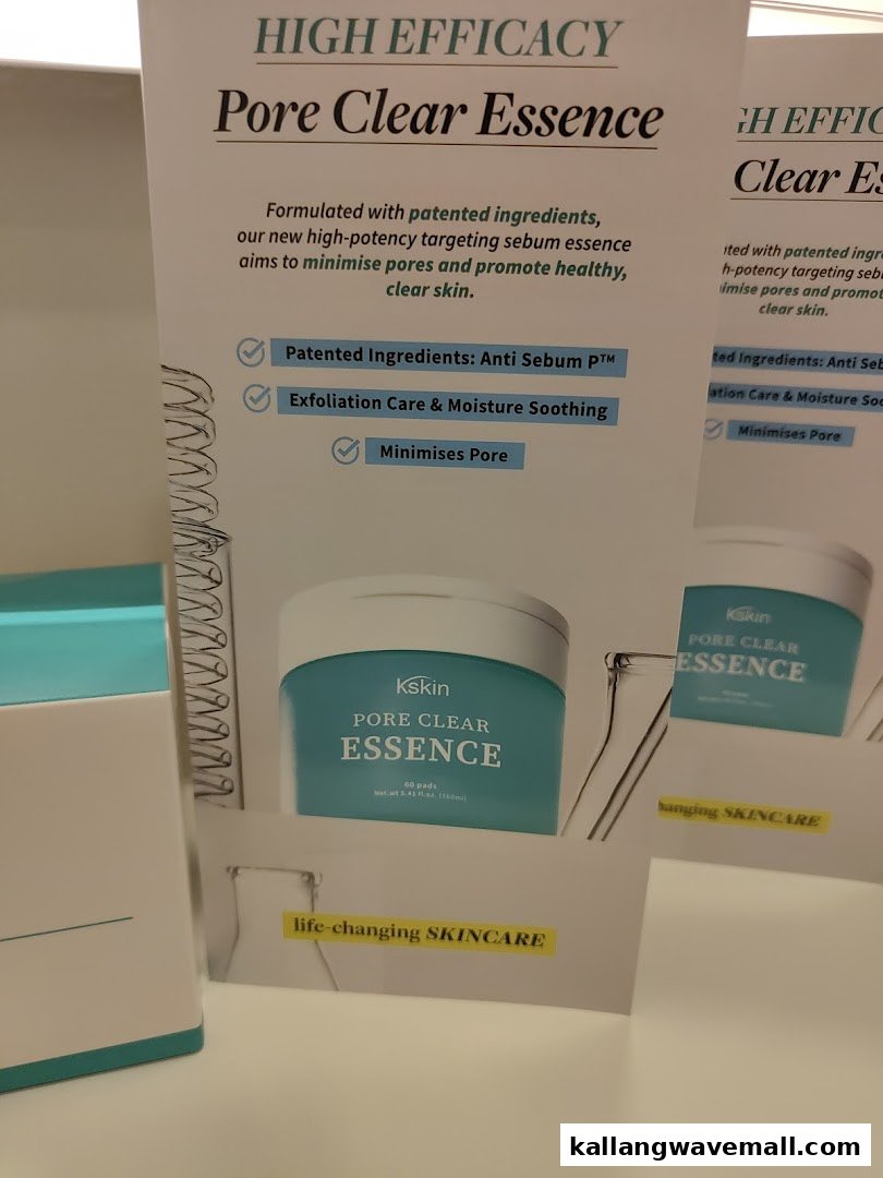 A Kskin display advertising 'Pore Clear Essence' skincare product, highlighting its benefits for clear skin.