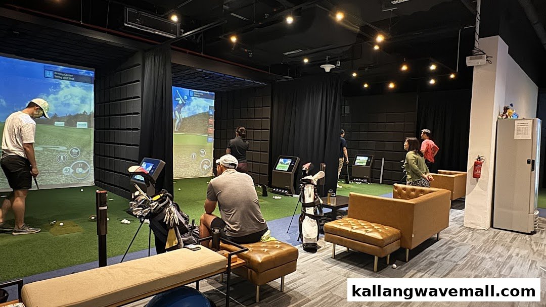 People enjoy playing golf in multiple indoor simulator bays at Lip Golf, featuring comfortable seating areas.
