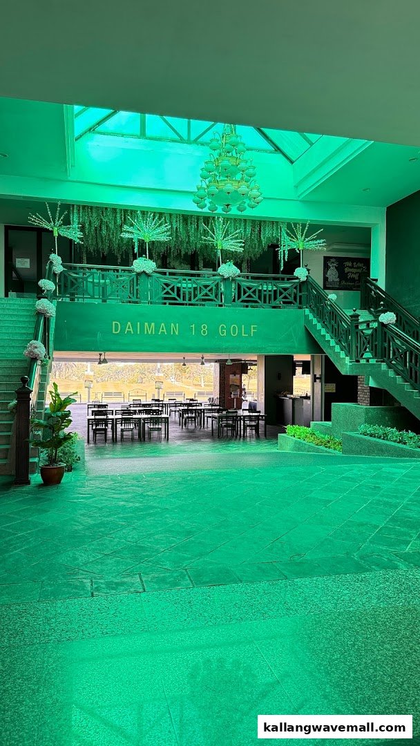 Spacious indoor lounge area at a golf club, featuring tables, chairs, and a view of the golf course.