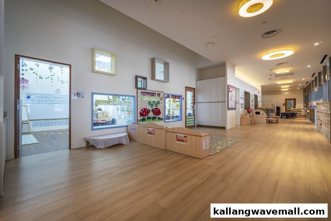 A bright, spacious hallway inside Lorna Whiston Preschool, featuring classroom entrances and learning displays.