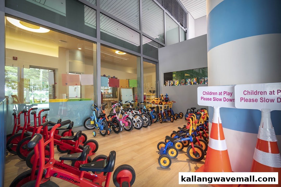 An indoor play area at Lorna Whiston Preschool featuring various children's bikes and tricycles.