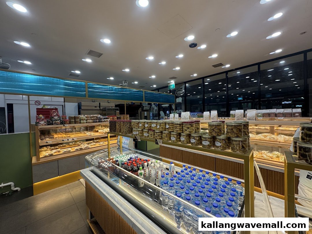 A brightly lit interior of MK Levure Naturelle, showcasing a wide array of freshly baked goods, cookies, and beverages.