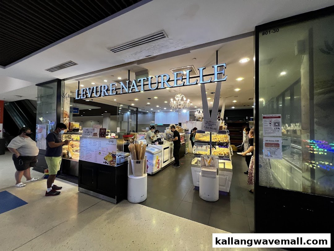 The storefront of MK Levure Naturelle, a bakery and dessert shop, with customers inside.