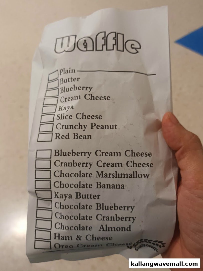 A paper bag displaying a comprehensive list of various waffle flavors available for order.