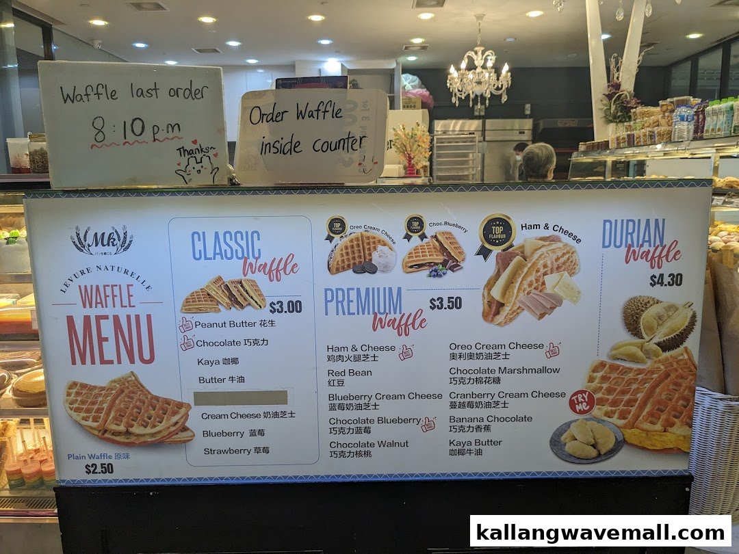 A vibrant menu board for MK Levure Naturelle, showcasing various waffle flavors and prices.
