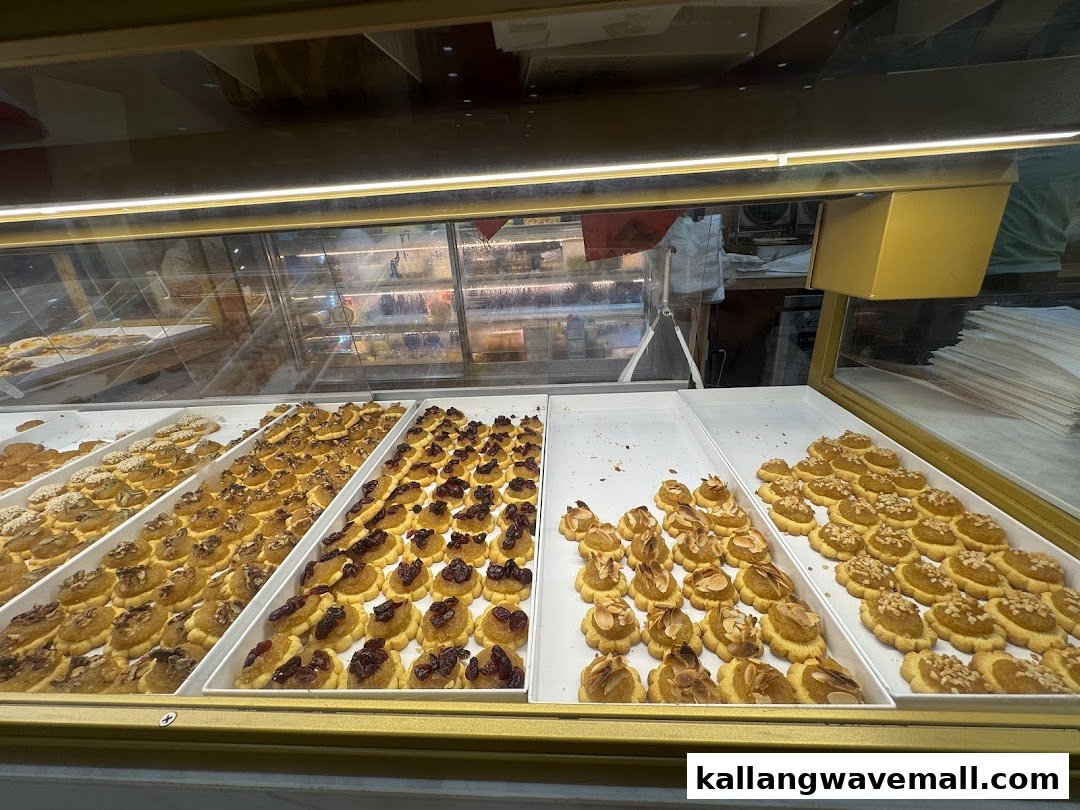 A vibrant display case showcasing an assortment of freshly baked cookies and pastries at MK Levure Naturelle.