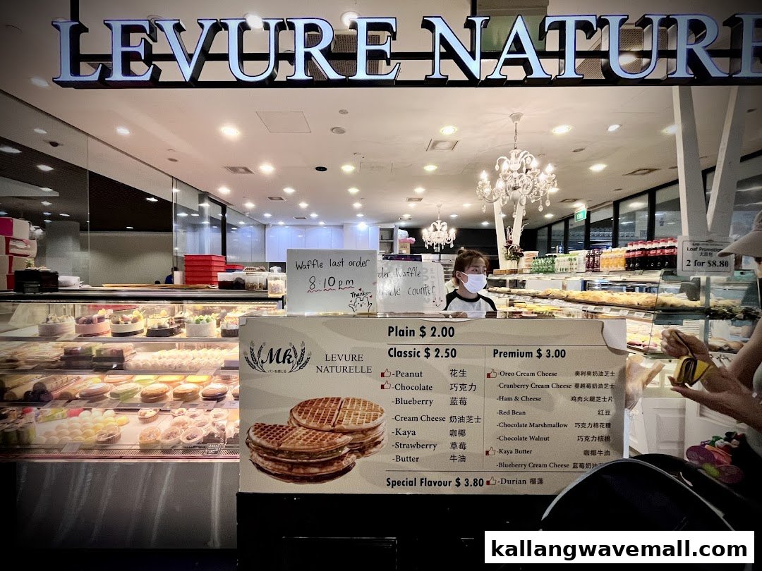 A detailed menu board for waffles with various fillings and prices, set against the backdrop of a bakery interior.