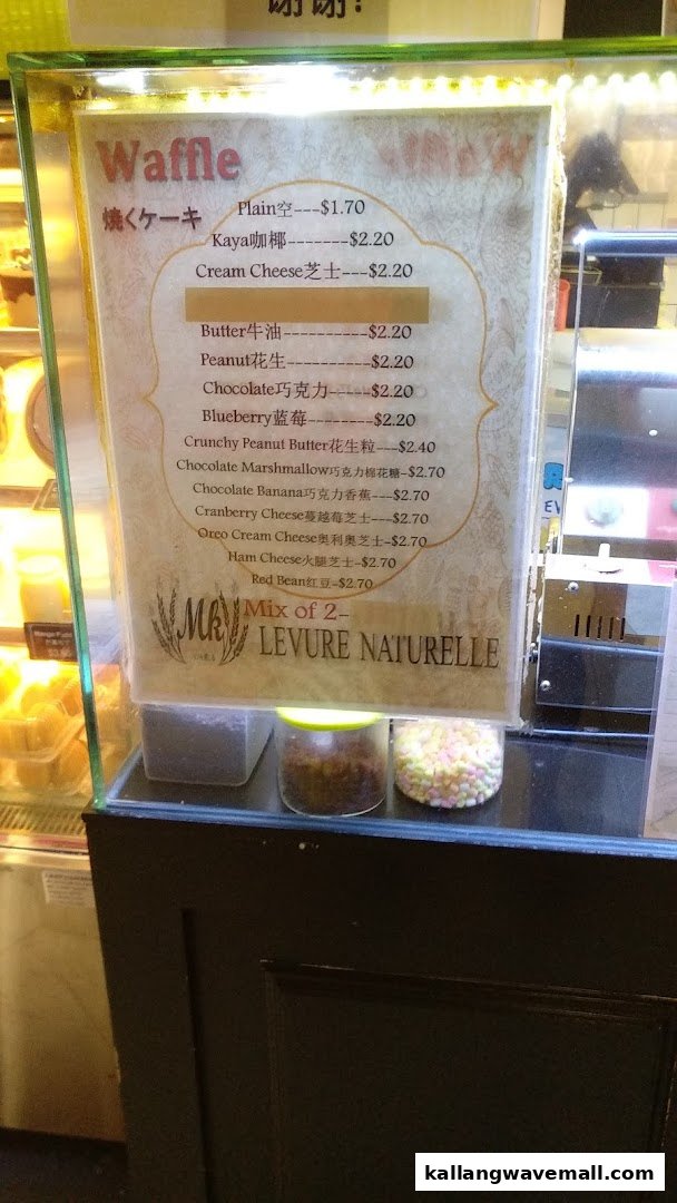 A menu board displaying various waffle flavors and their prices from MK Levure Naturelle.